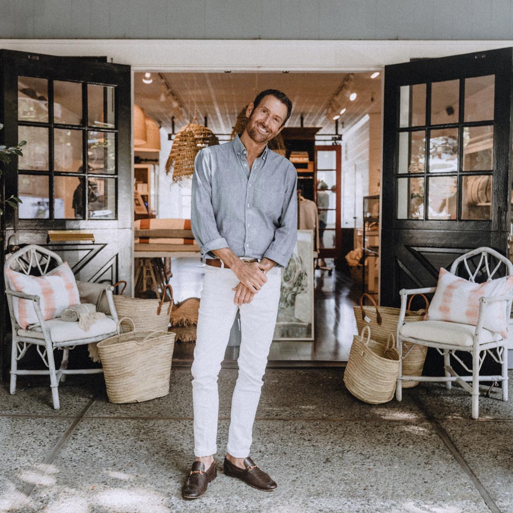 christopher downs in front of his hair salon