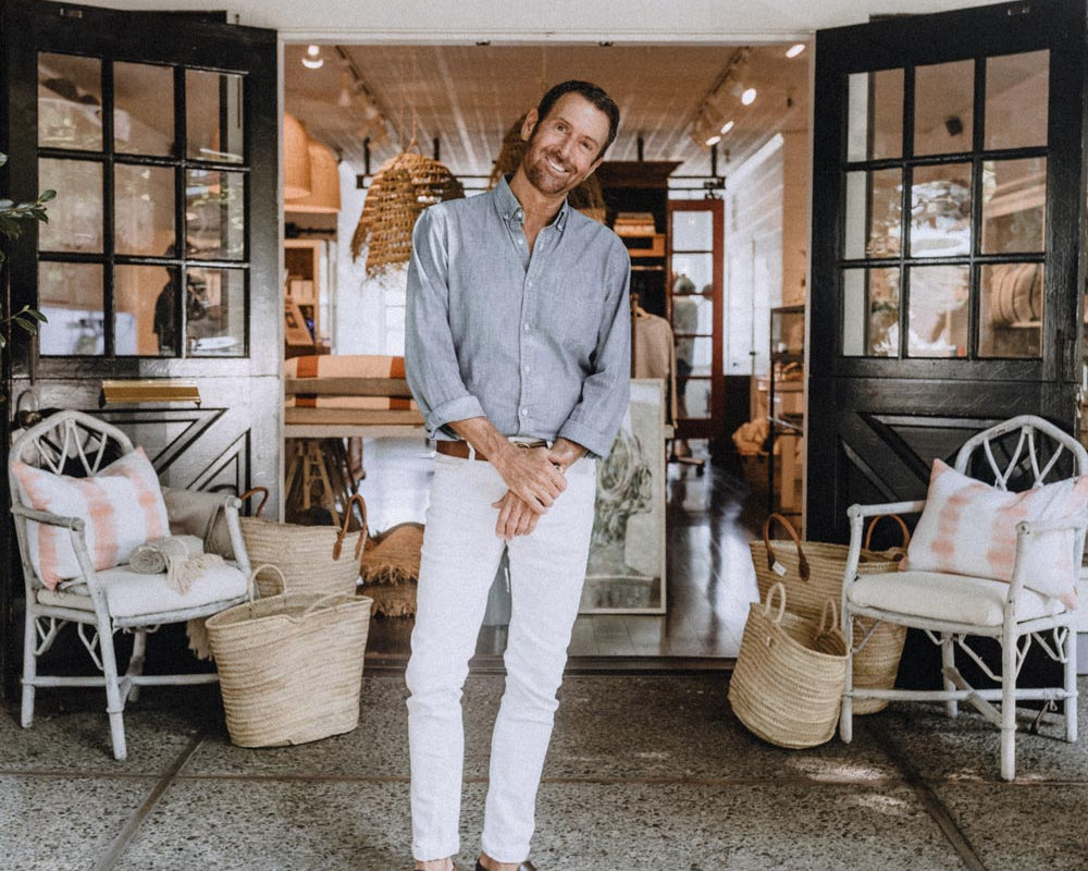 christopher downs in front of his hair salon