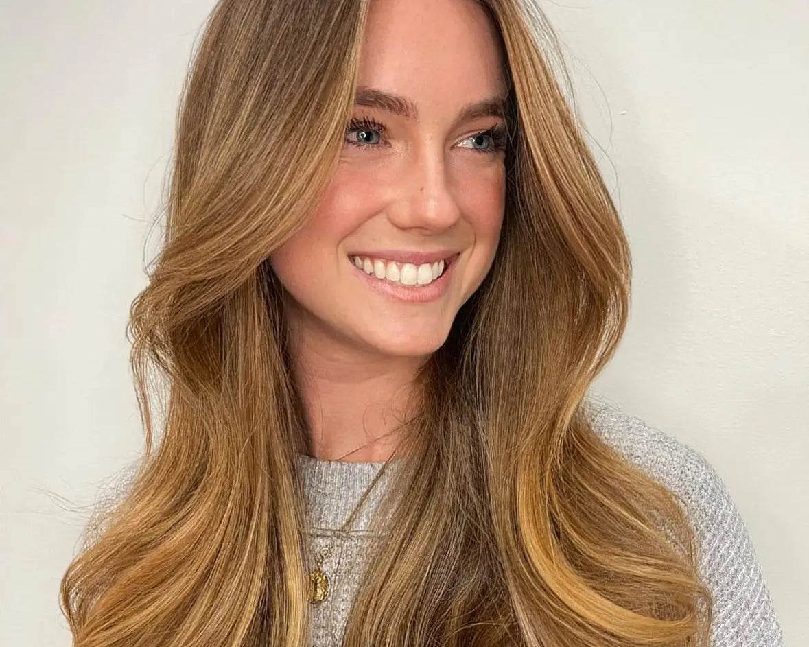 woman smiling with long copper-colored hair