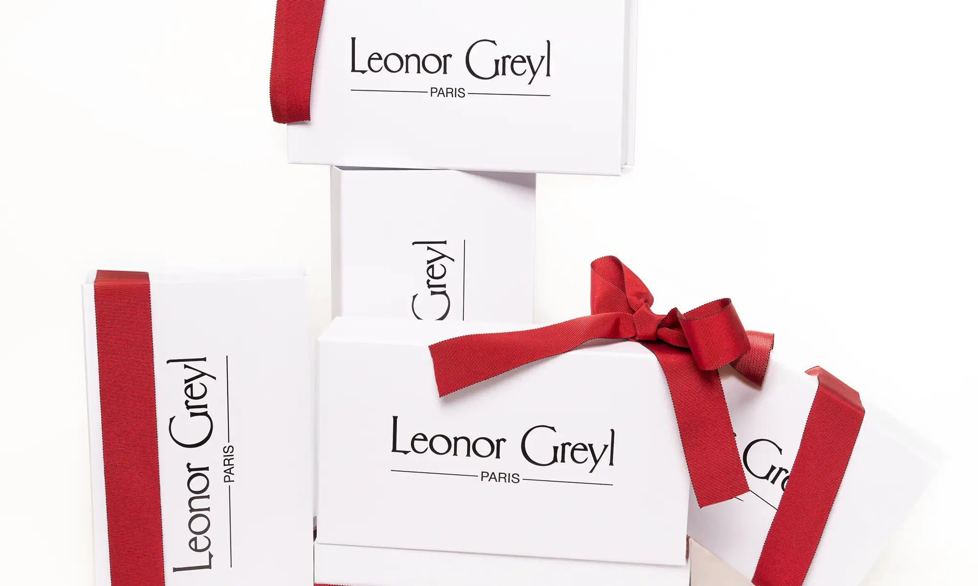 Leonor Greyl gift boxes tied with red ribbons