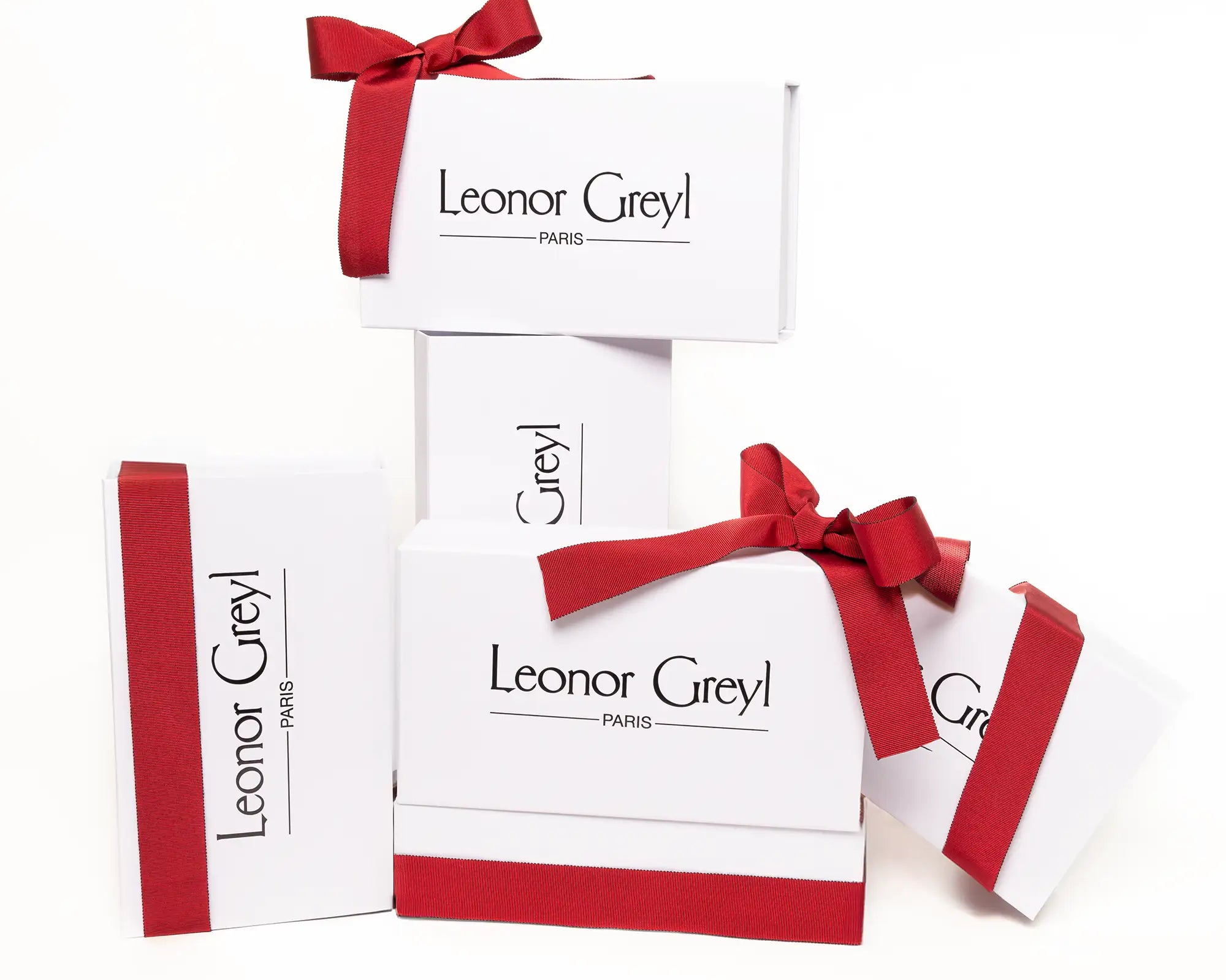 Leonor Greyl gift boxes tied with red ribbons