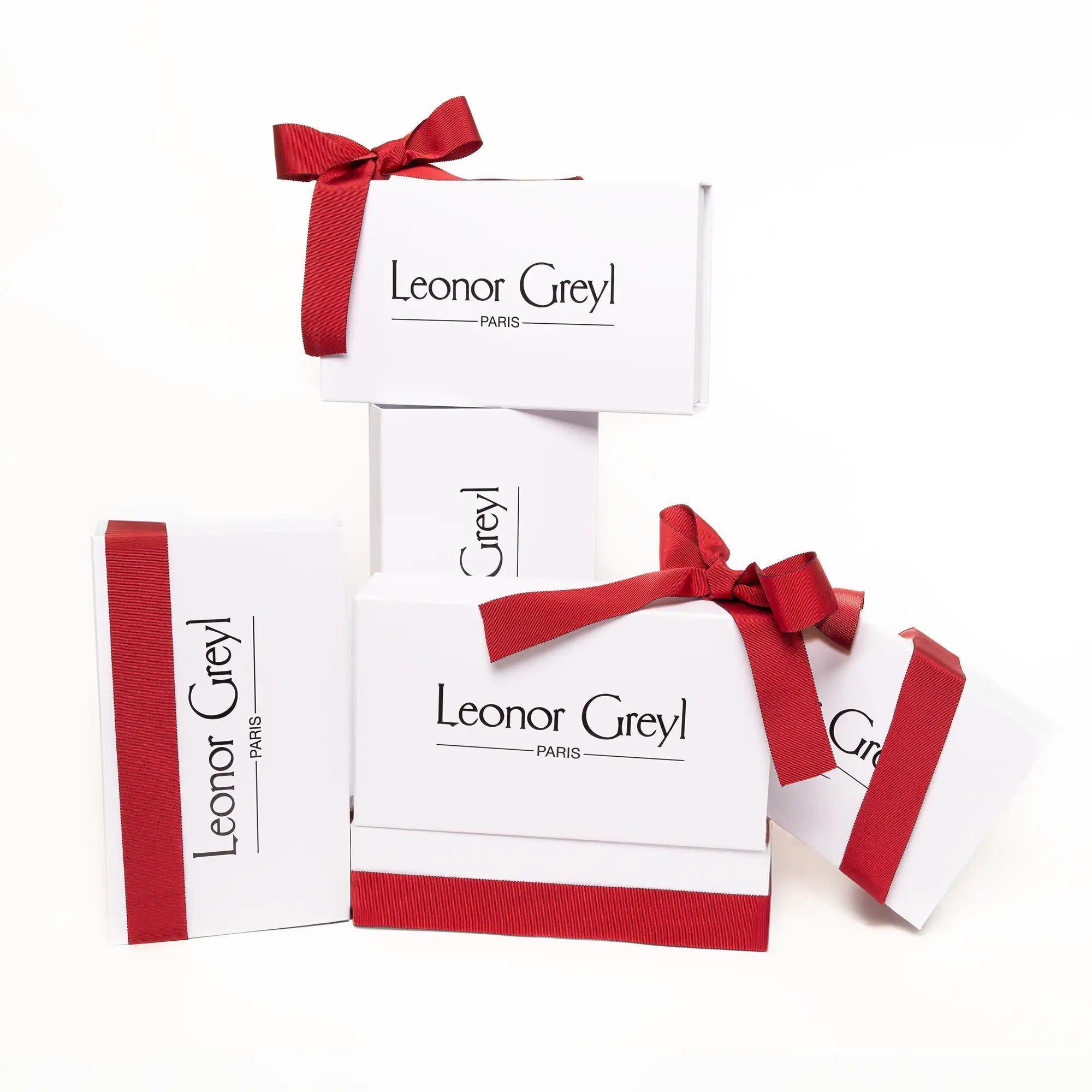 Leonor Greyl gift boxes tied with red ribbons