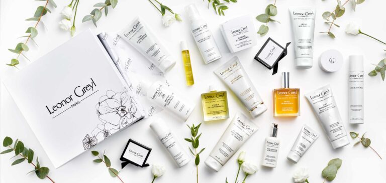 Leonor Greyl hair products and greenery on a white background