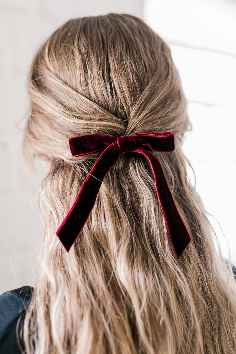 Leonor Greyl Trace Henningson hair bow in rouge, pinning back blonde hair