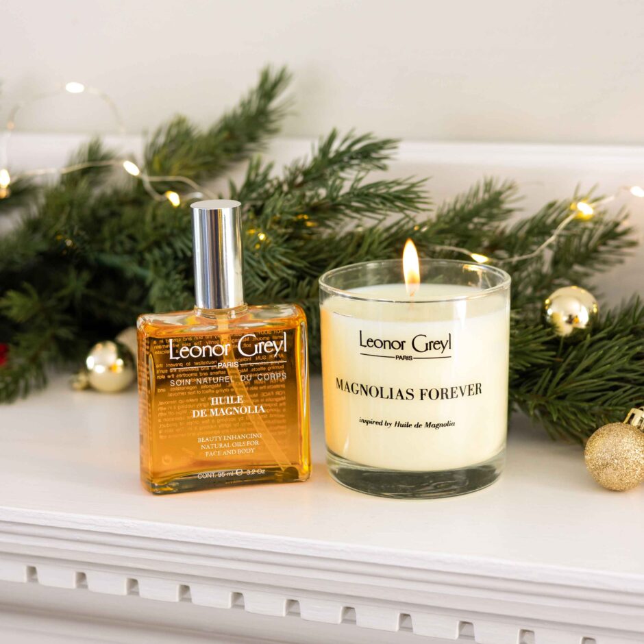 Huile de Magnolia & Magnolia’s Forever Candle Duo on a mantle with holiday greenery and decorations